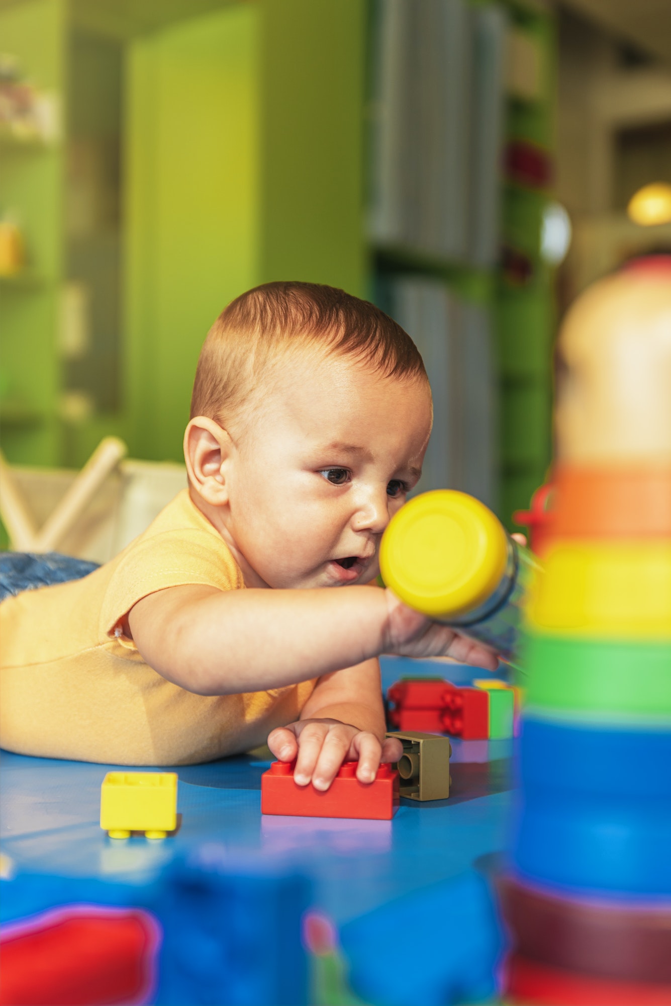 happy-baby-playing-with-toy-blocks-in-the-kindergarten-.jpg